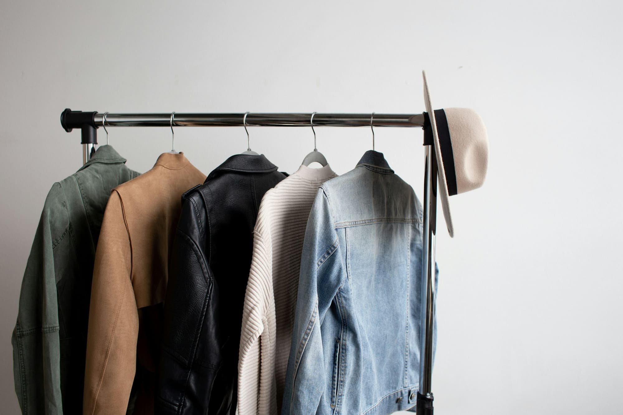 Leather jacket, knit and denim jacket on a rail